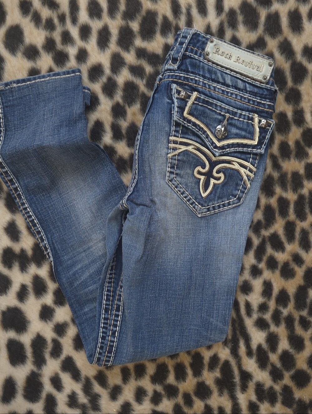Rock Revival Women's Blue Distressed Jeans with Fleur-de-Lis Stitching